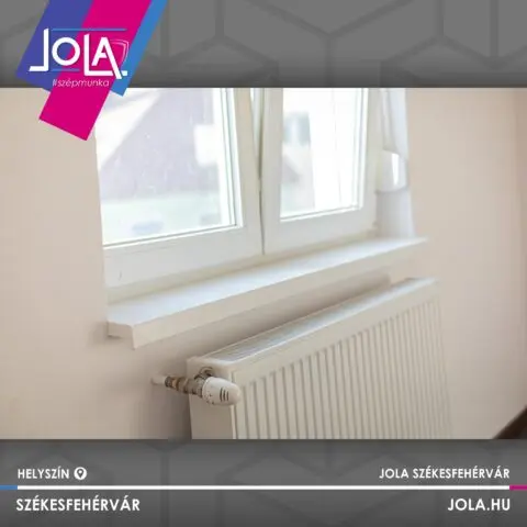 Fehér radiátor termosztatikus szeleppel ablak alatt Székesfehérváron
